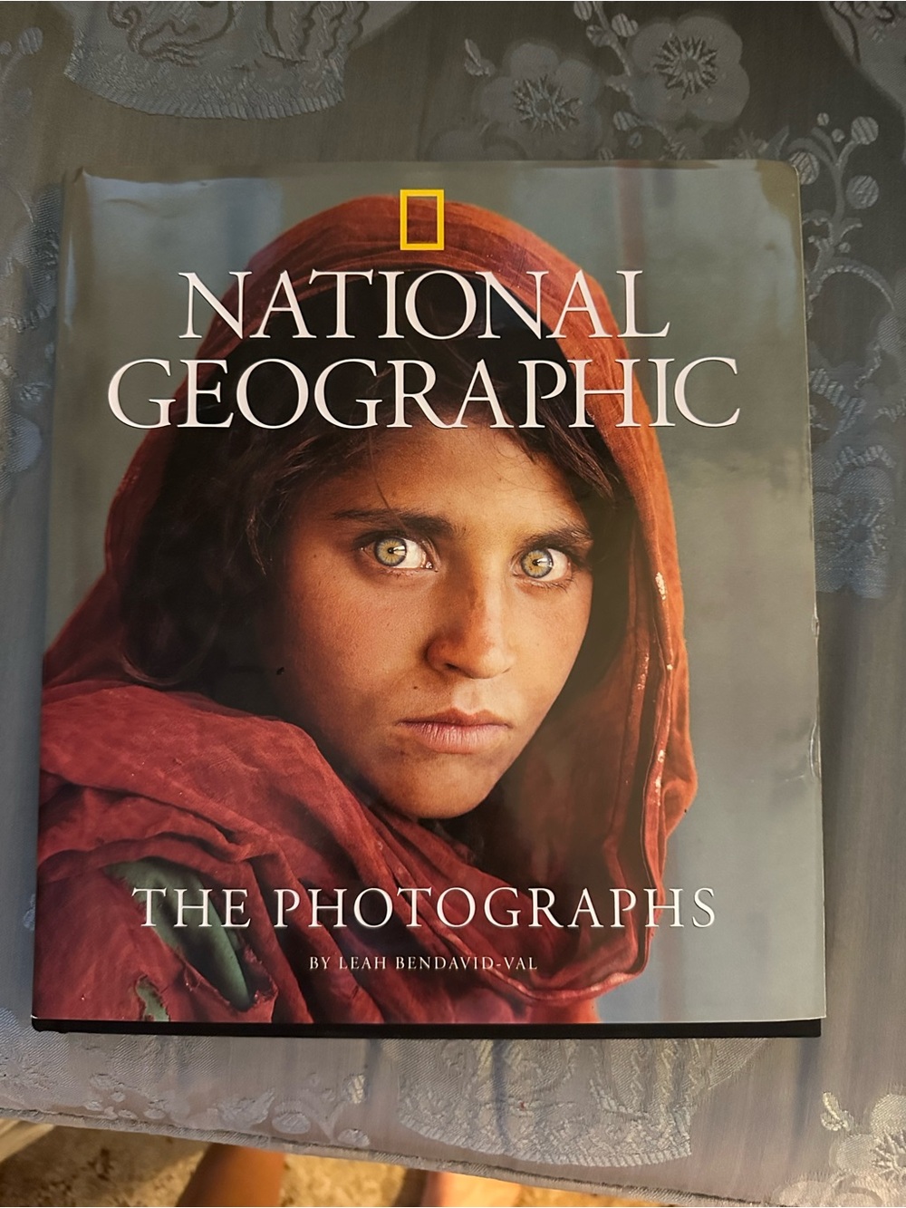 National Geographic Hardcover Book with Red Cover and Brown-Toned Portrait
